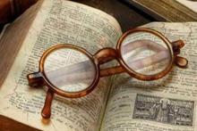 eyeglasses laying on a book